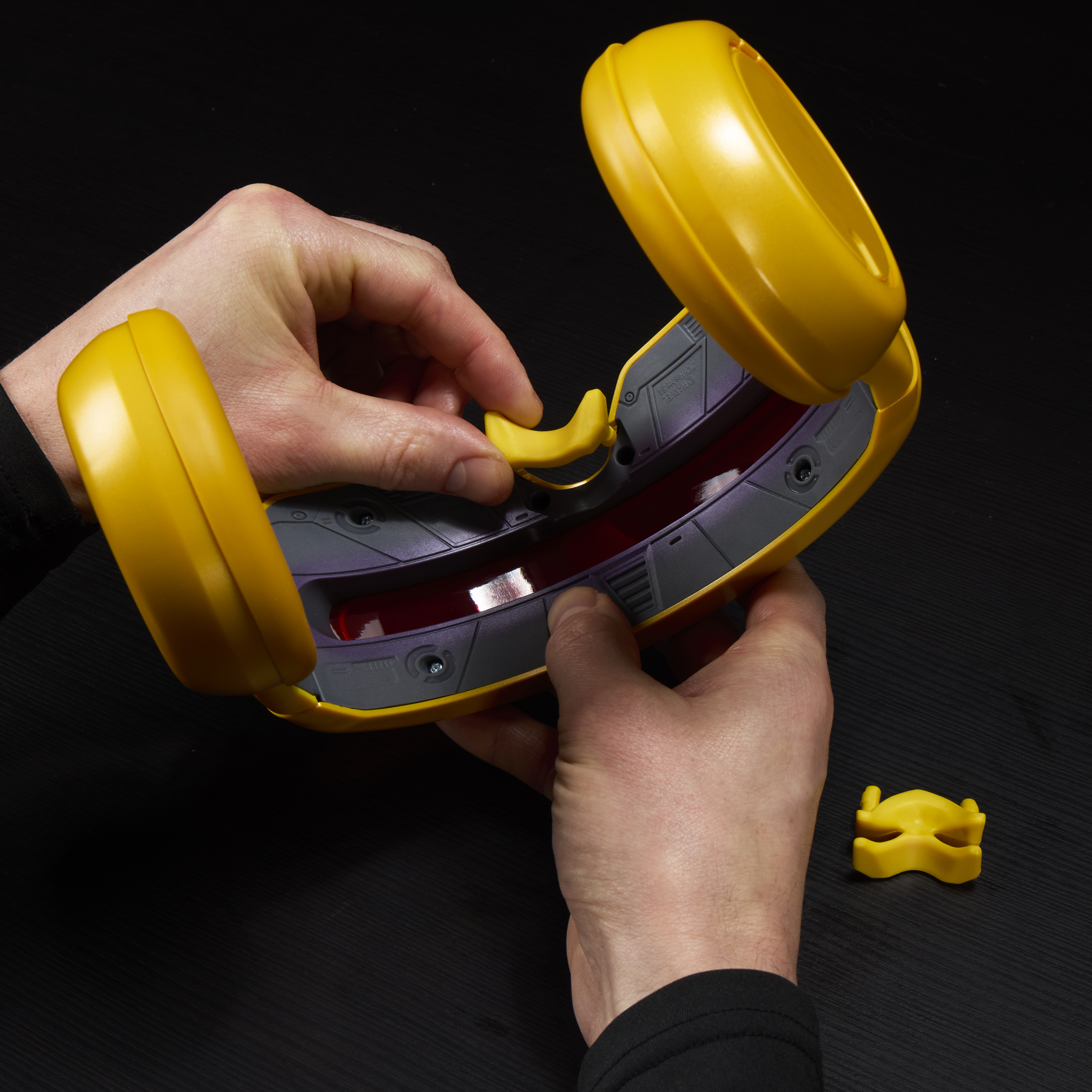 A man holds the X-Men Cyclops Visor against a dark background