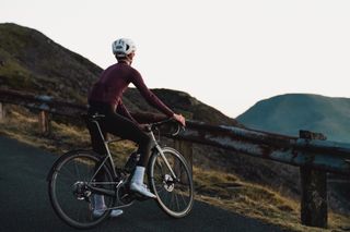 Image shows cyclist having a rest mid way through a training ride in Wales