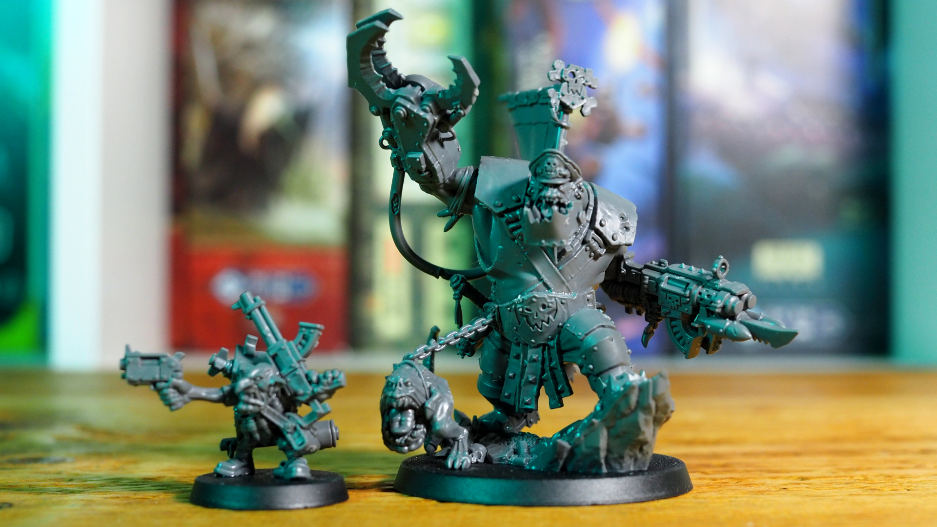 Warhammer 40K Orks Warboss and Ammo Runt models seen front-on, on a wooden table