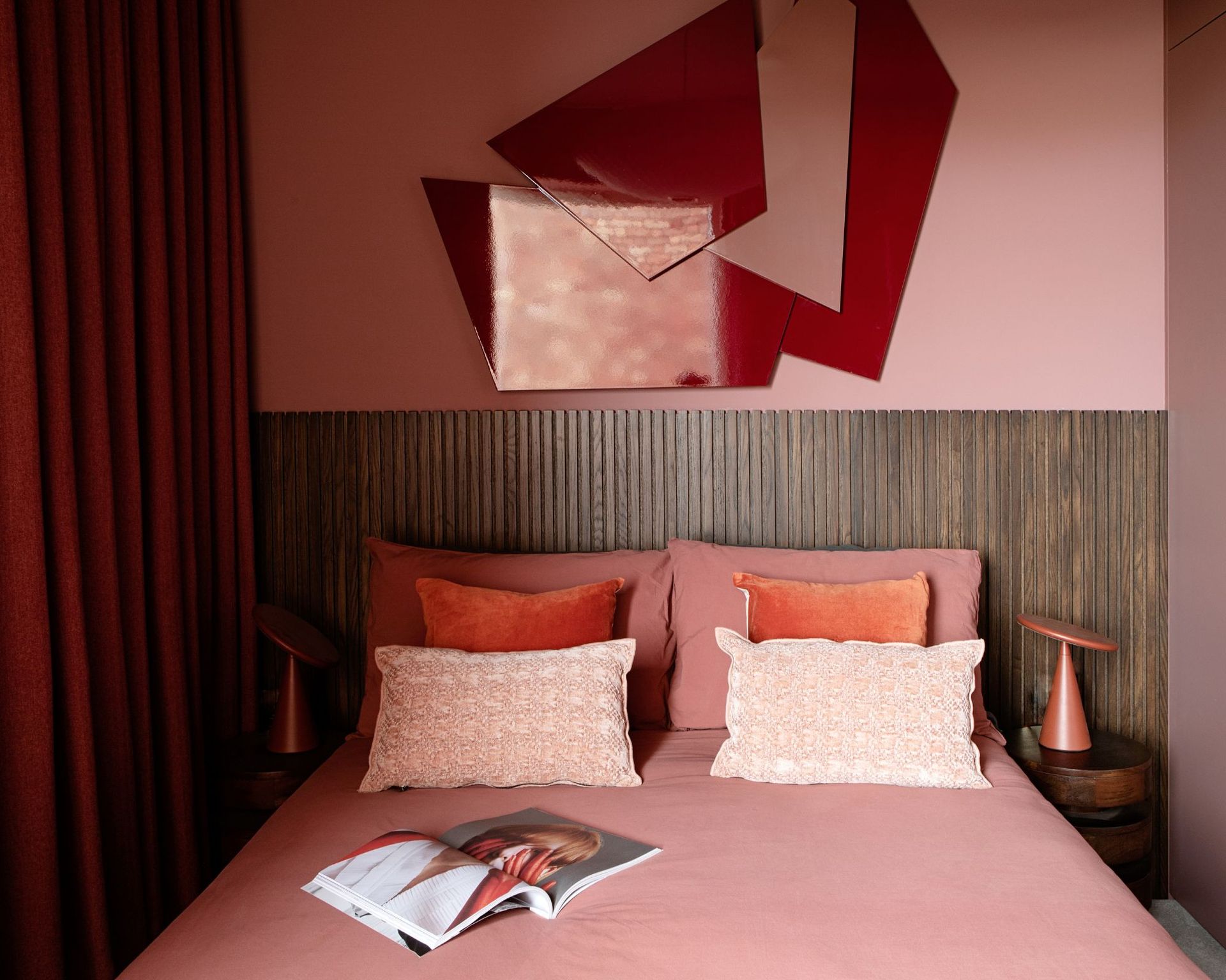 pink bedroom with red wall art