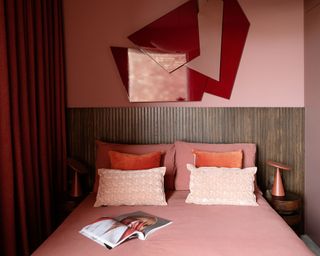 pink bedroom with red wall art