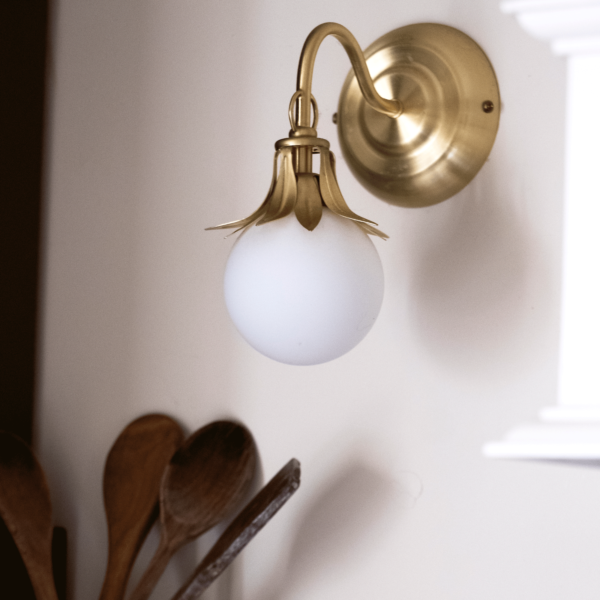 close up of a brass and glass wall lamp