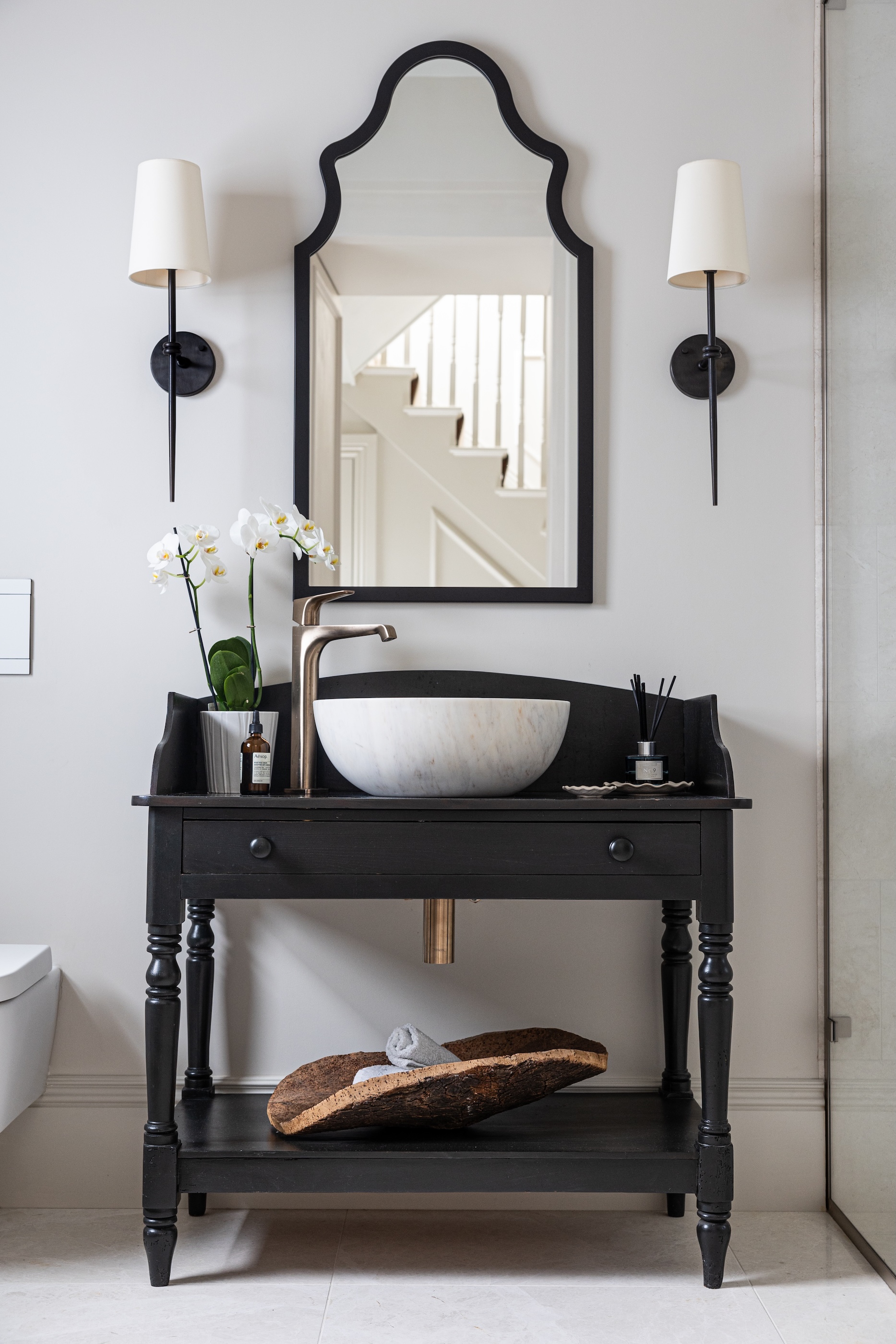 A vintage washstand with a chic black and white theme