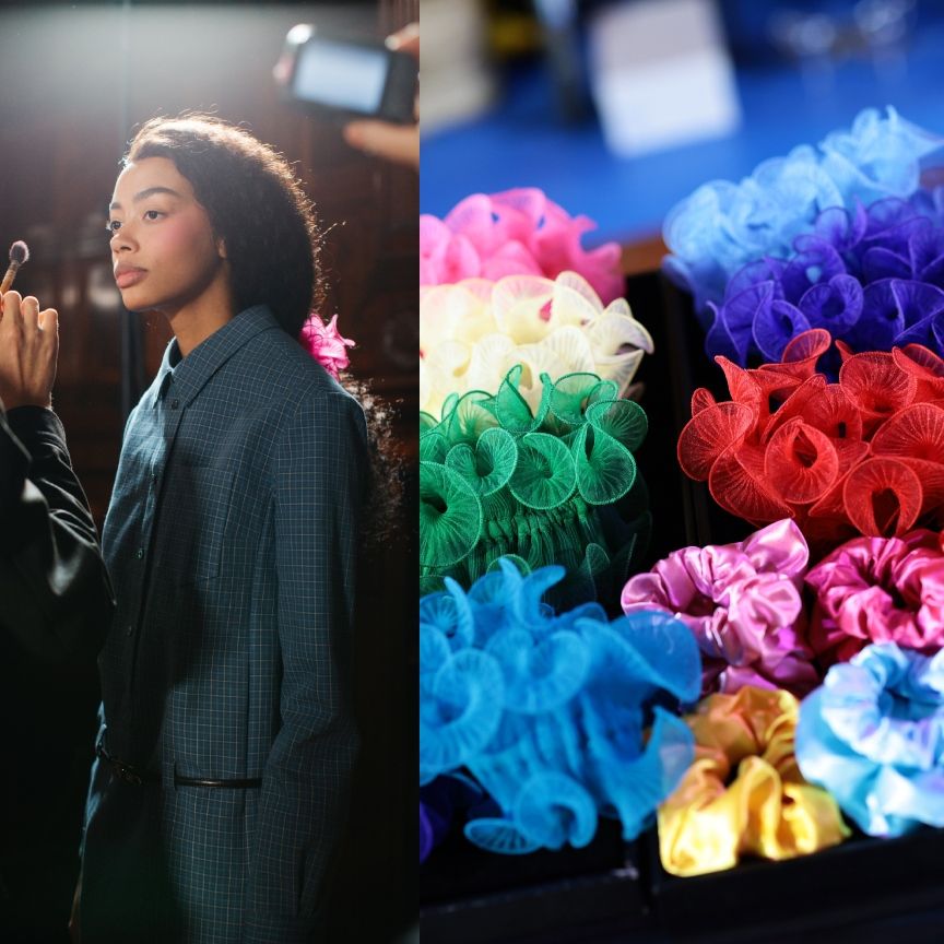 a woman getting makeup applied next to a tray of colorful scrunchies