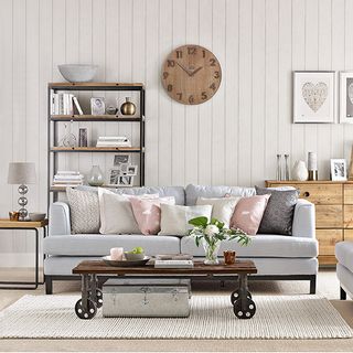 white living room with sofa set and carpet flooring