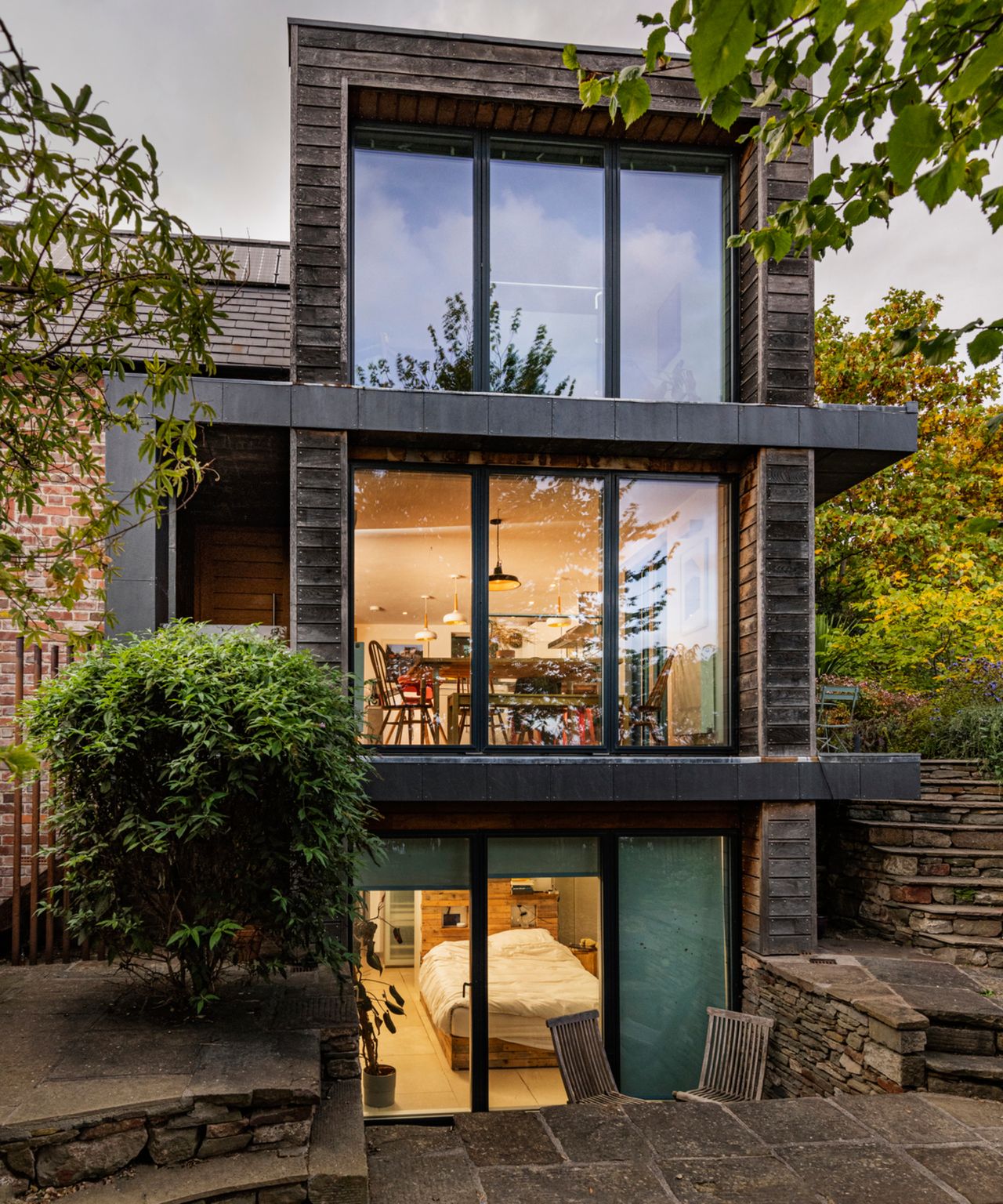 exterior shot of eco home with 3 levels of timber clad extension