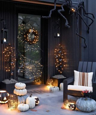 Black front porch decorated with halloween decor