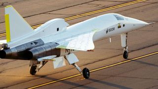 closeup photo of a needle-nosed white and silver plane on a runway