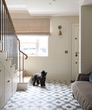 Hallway with built-in storage and patterned tiled floor and seating