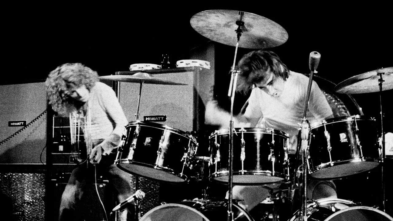Keith Moon drumming onstage as Roger Daltrey looks on
