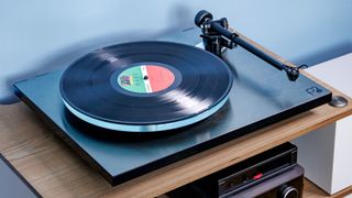 The Rega Planar 3 RS on an entertainment stand.