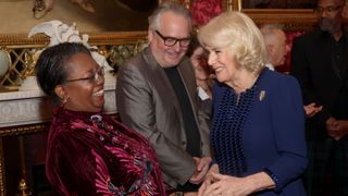 Queen Camilla (R) shares a joke with Malorie Blackman during a reception for the BBC's 500 Words Finalists at Buckingham Palace on February 28, 2024