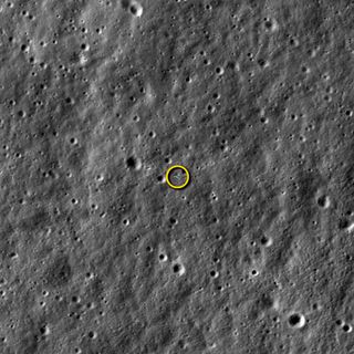 NASA's LADEE moon dust probe (circled) is photographed by the agency's powerful Lunar Reconnaissance Orbiter in this image released on Jan. 29, 2014. The image, taken on Jan. 14, shows LADEE from a distance of 5.6 miles (9 kilometers) away as the two spacecraft passed each other as they orbited the moon. Both spacecraft are orbiting the moon with velocities near 3,600 mph (1,600 meters per second), so timing and pointing of LRO must be nearly perfect to capture LADEE in an LROC image.