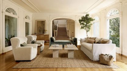 Best indoor furniture stores. Grand, large living room with seating area, two sofas and two lounge chairs all positioned around a coffee table, relaxed, neutral color palette
