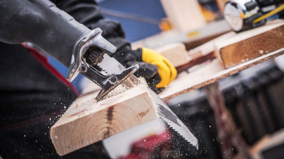 Reciprocating saw cutting through wood 