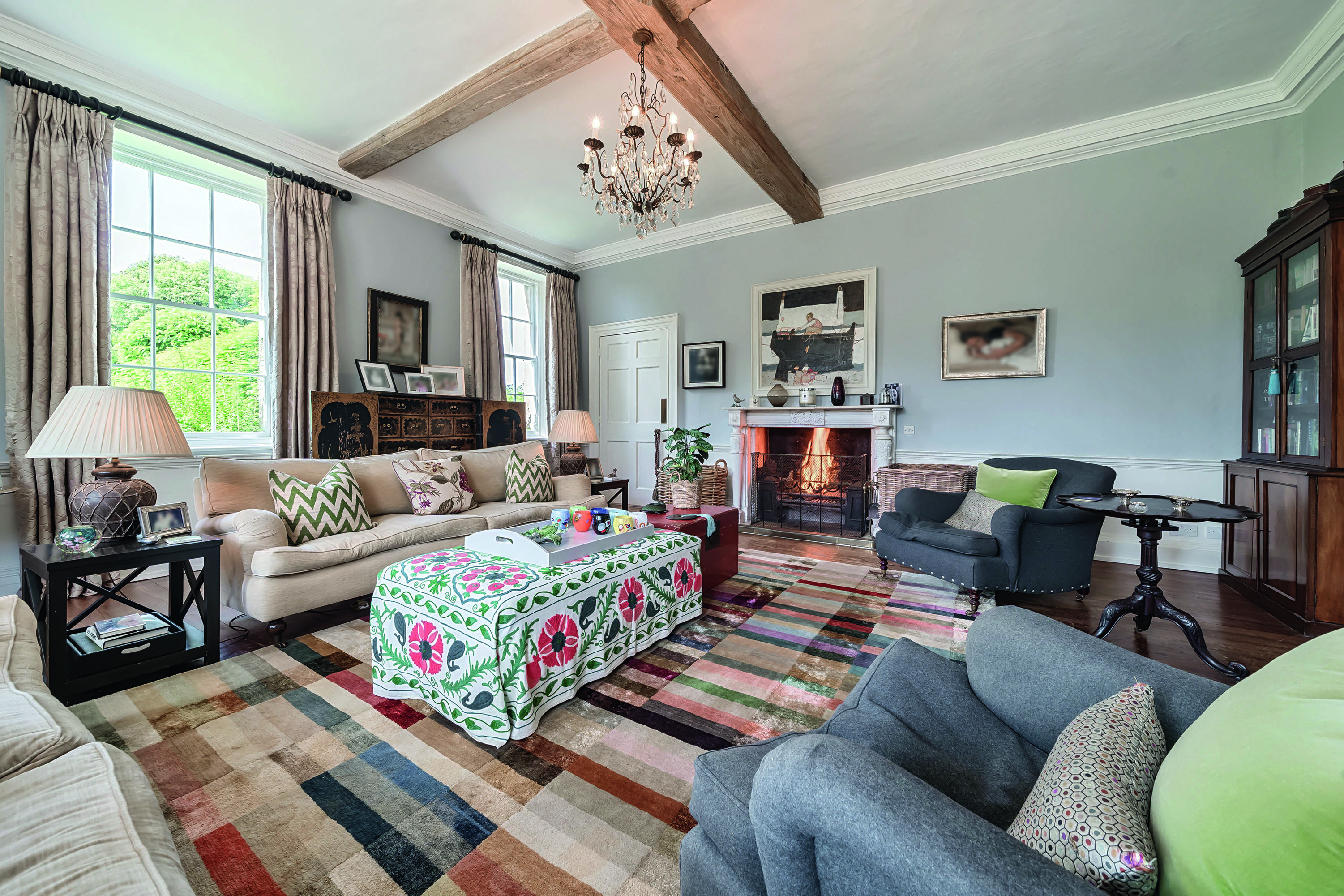 Images of the restored interiors of Polstead Hall, featuring traditional furniture, exposed beams and classical elements