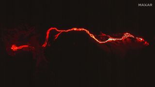 The glowing river of lava from the Cumbre Vieja volcano can be seen reaching the Atlantic Ocean in this image obtained by Maxar Technologies on 29 Sept. 2021.