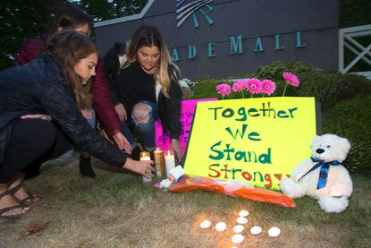 A memorial for the five victims of a mass shooting at a Washington State mall