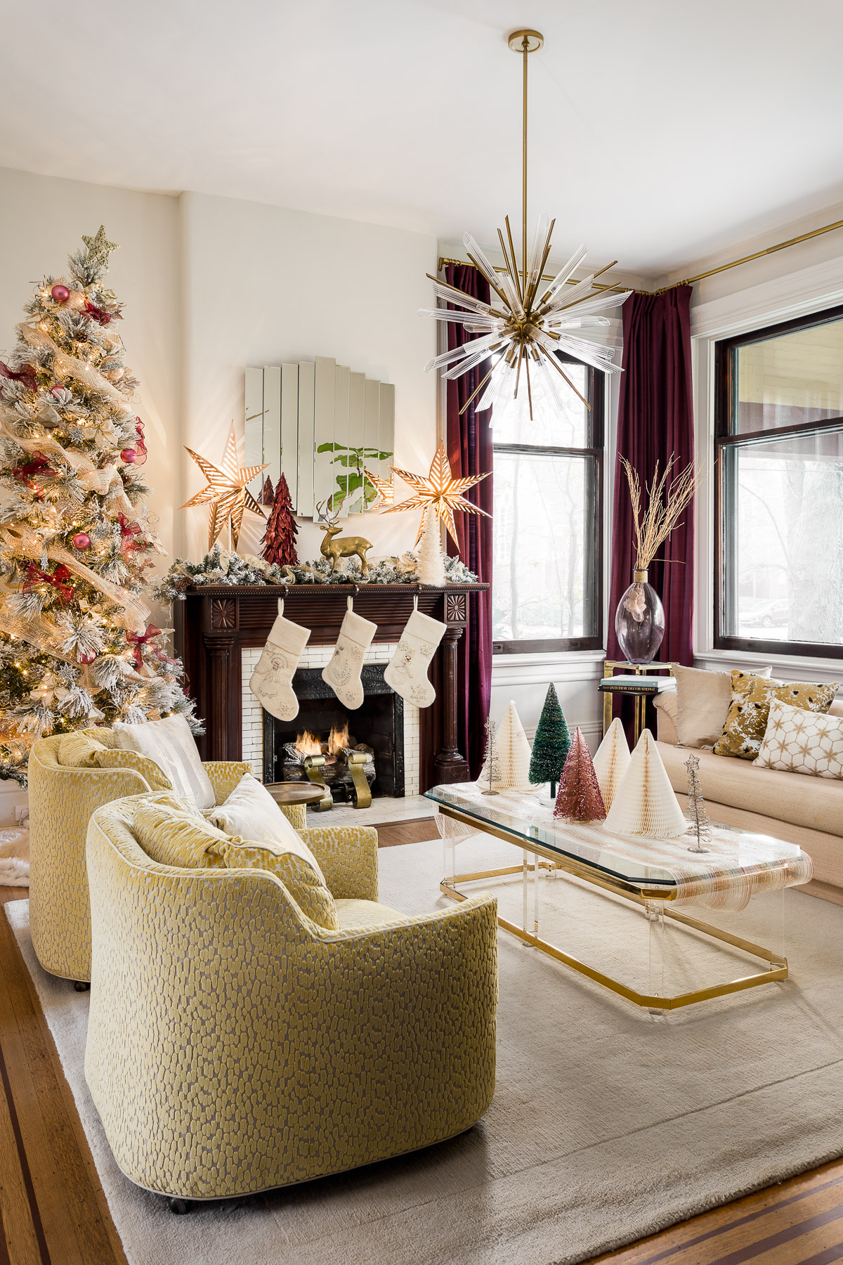 Living room decorated with festive red, gold, and green colors.