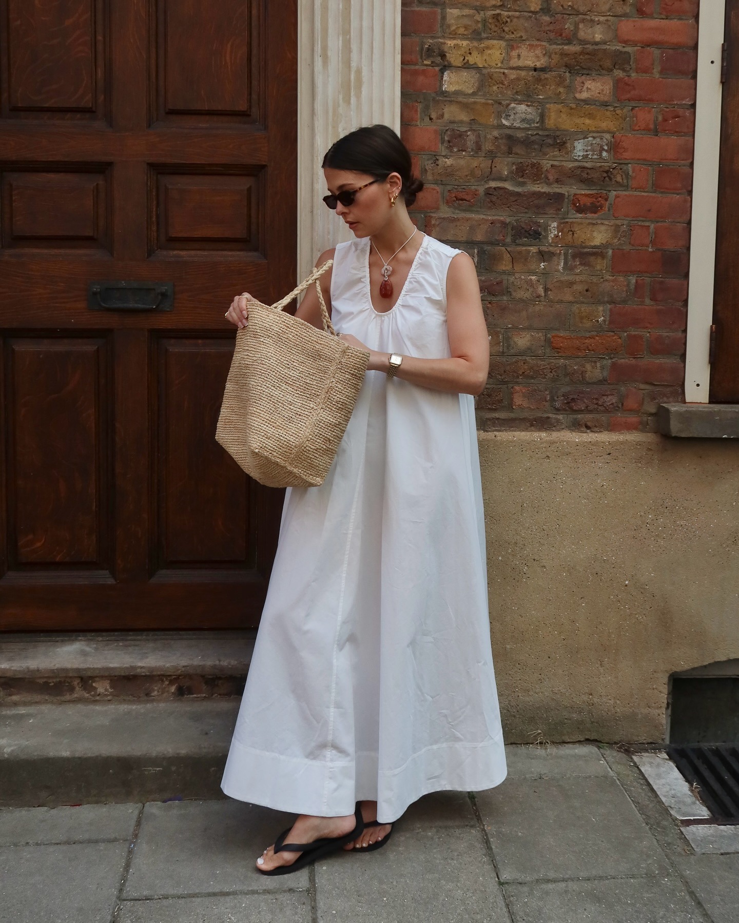 Woman wearing white dress and basket bag