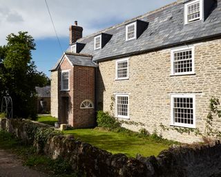 old renovated farmhouse exterior with 30 pane windows