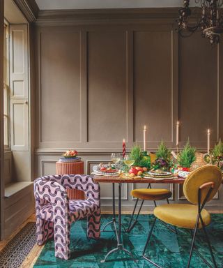 Dining table, green rug, candles