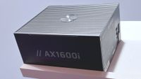 A photo of a Corsair AX1600i Shift PSU resting on a pink wall shelf