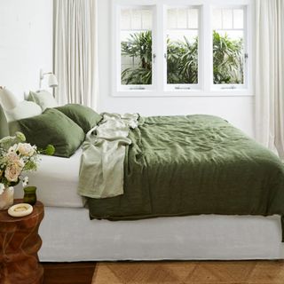 Olive Stripe, Sage, and White Bedding Bundle on a bed.