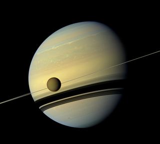 Titan dangles in front of Saturn in this image snapped by an instrument aboard NASA's Cassini spacecraft.