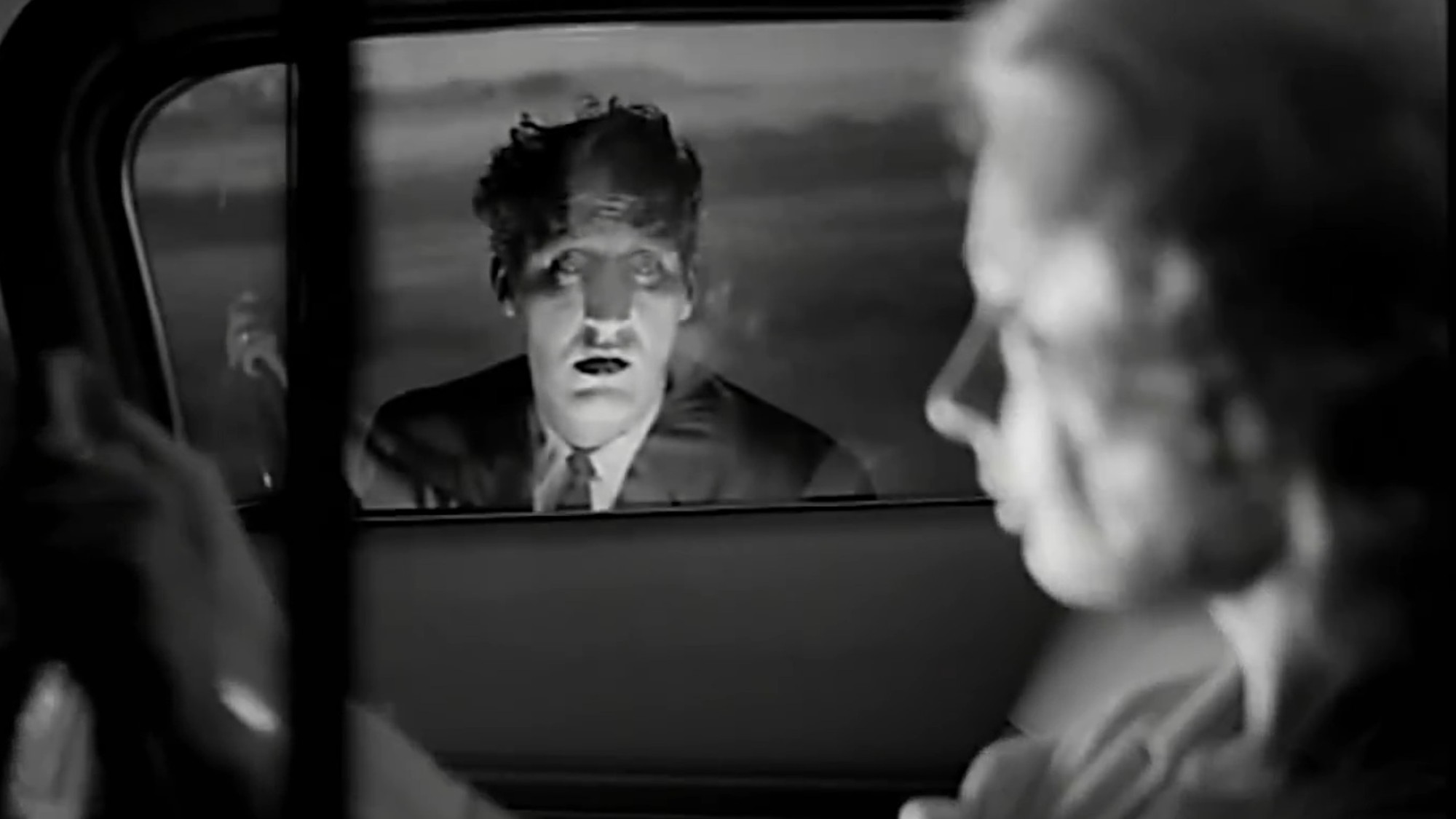 A ghastly figure at a car window in Carnival of Souls