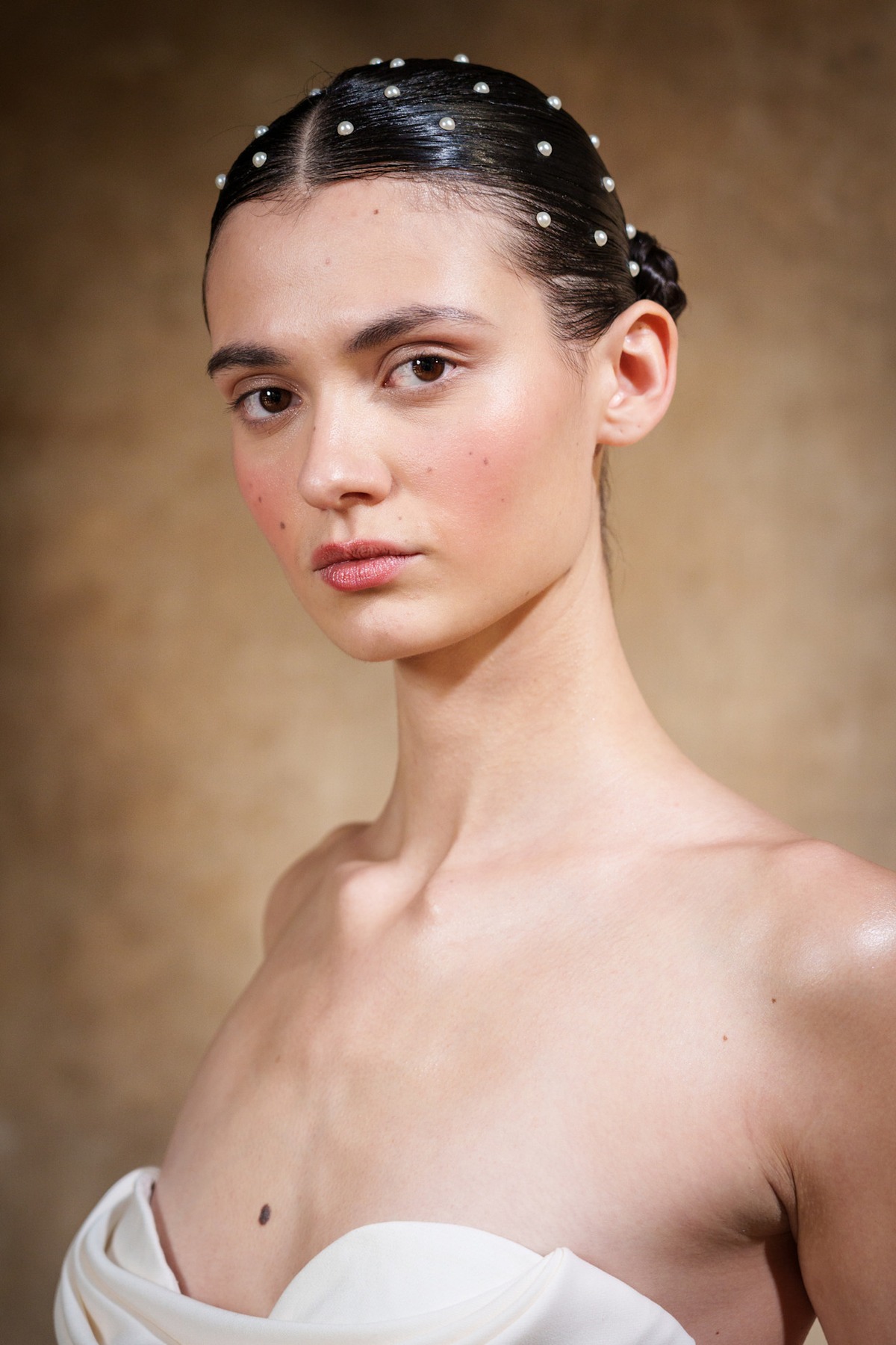 A model showing off a pearly wedding hairstyle.