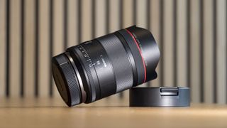 Canon RF 14mm F1.4L VCM lens on a wooden surface