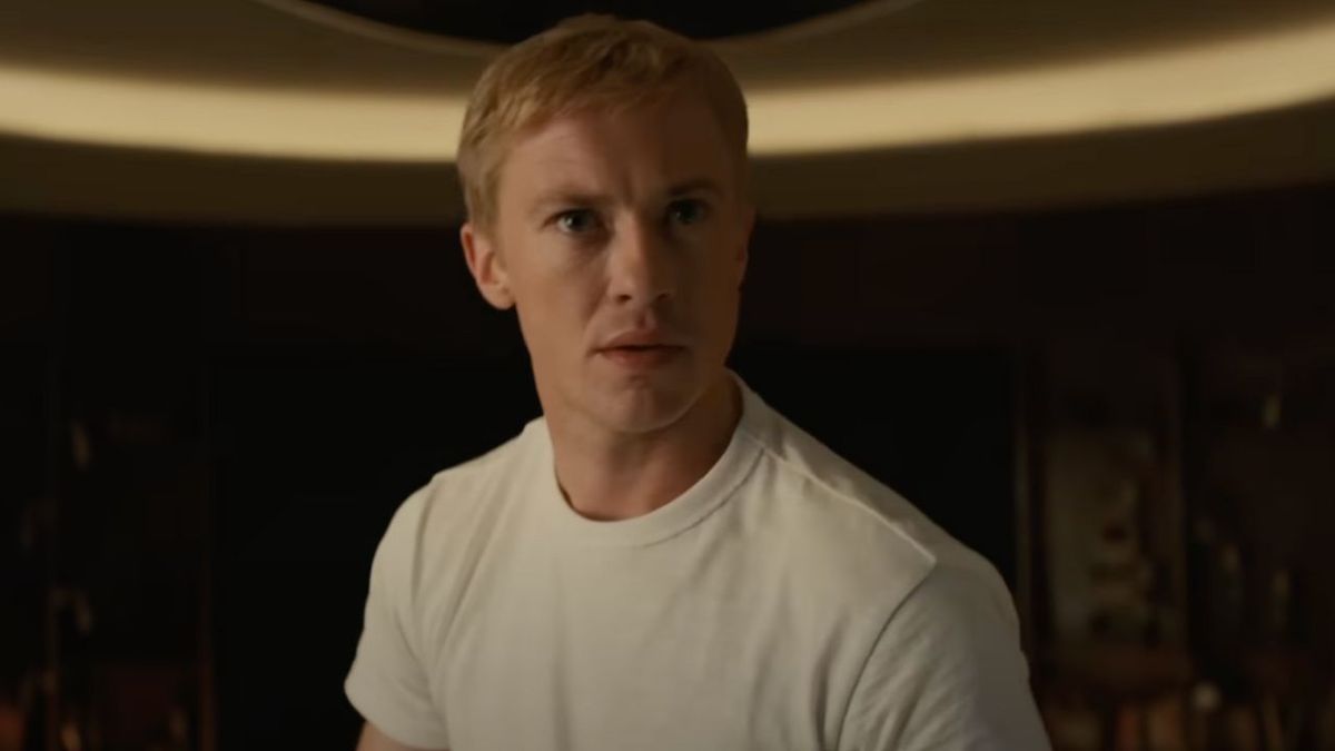 Joseph Quinn as Johnny Storm in The Fantastic Four: First Steps. He&#039;s wearing a white shirt and looking worried. 