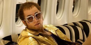 Elton John (Taron Egerton) sits on a plane in a scene from 'Rocketman'