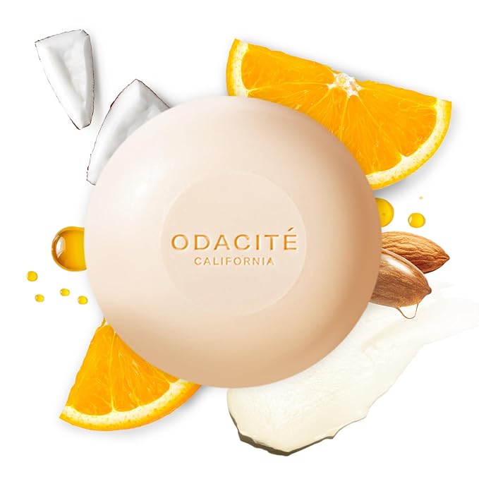 An Odacité shampoo bar with oranges and coconuts behind it