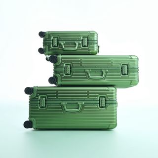 Stack of Rimowa green suitases