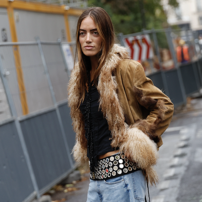 woman wearing a fur coat and a thick metallic belt