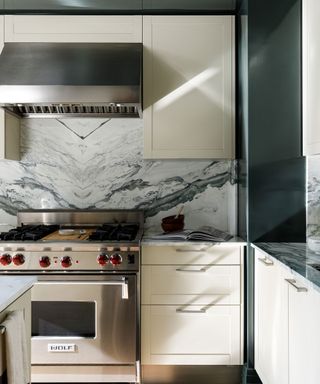 Palmolive kitchen with slab marble and green walls.and statement range