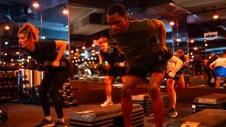 Barry’s Bootcamp class performing bent-over row with dumbbells