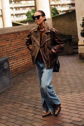 woman wearing leather jacket, jeans, and boots