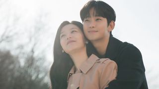 a man holds a woman from behind as they smile in the k-drama 'Queen of Tears'