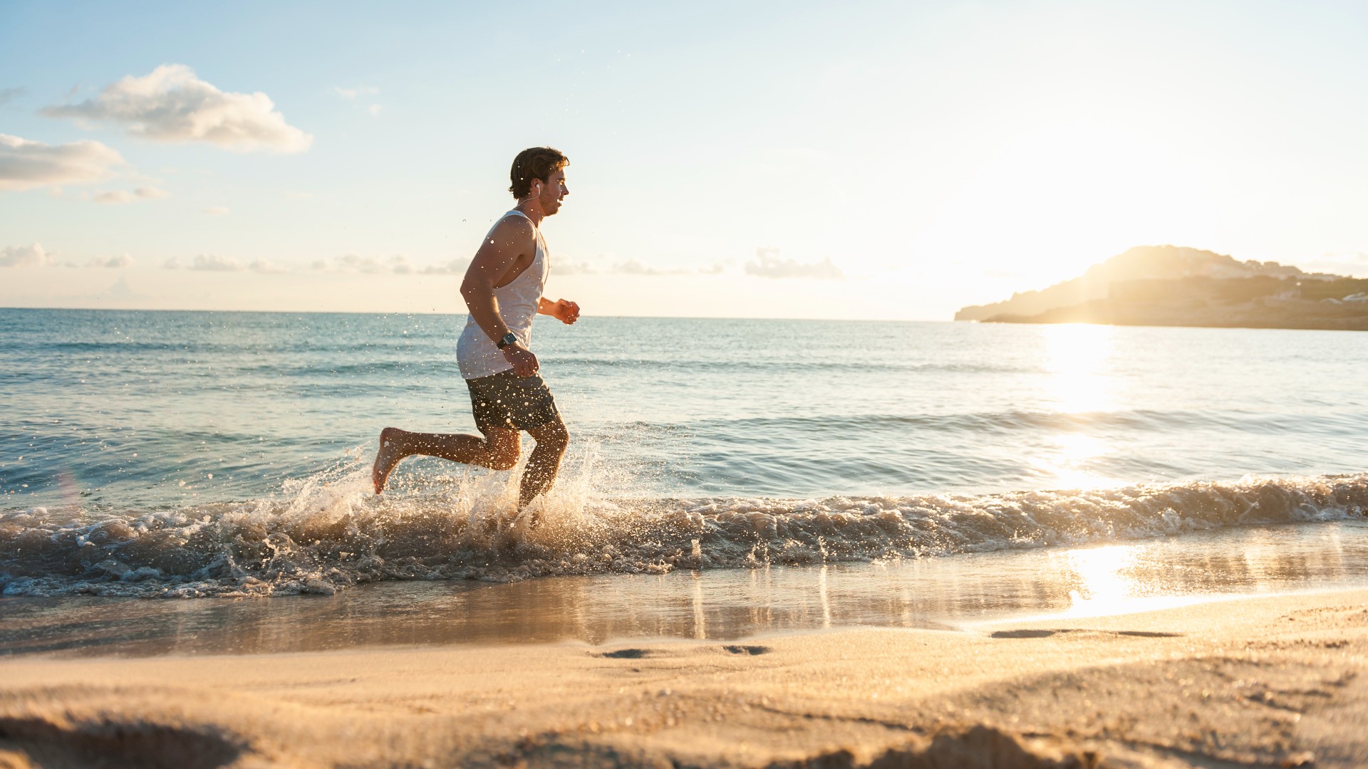 The man running in the water on the beach