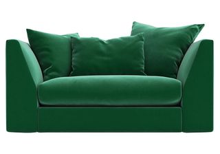 green coloured pillows on sofa with white background