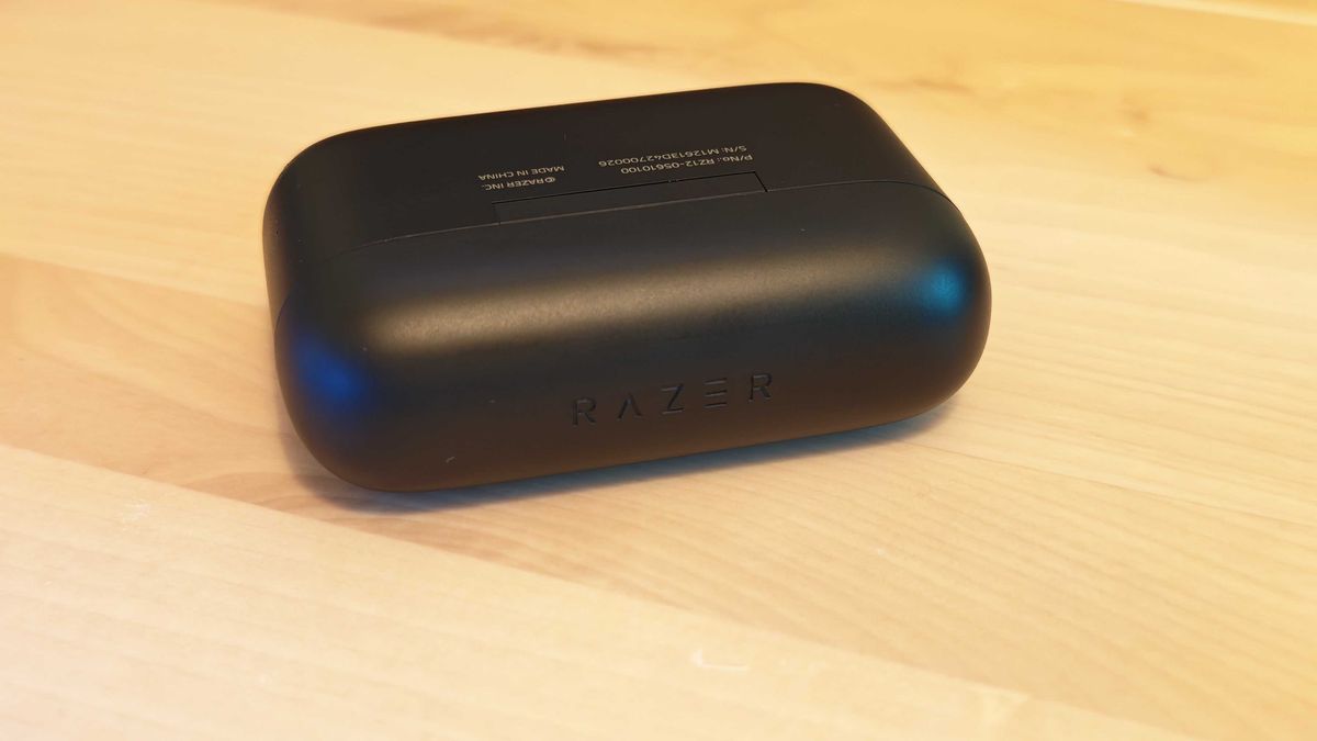 The Razer Hammerhead HyperSpeed gaming earbuds on a blank desktop surfcase.