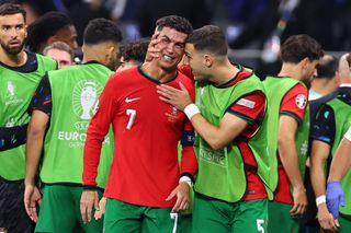 Cristiano Ronaldo of Portugal visibly upset after missing a penalty is spoken to by Diogo Dalot of Portugal during the UEFA EURO 2024 round of 16 match between Portugal and Slovenia at Frankfurt Arena on July 01, 2024 in Frankfurt am Main, Germany. (Photo by Robbie Jay Barratt - AMA/Getty Images)