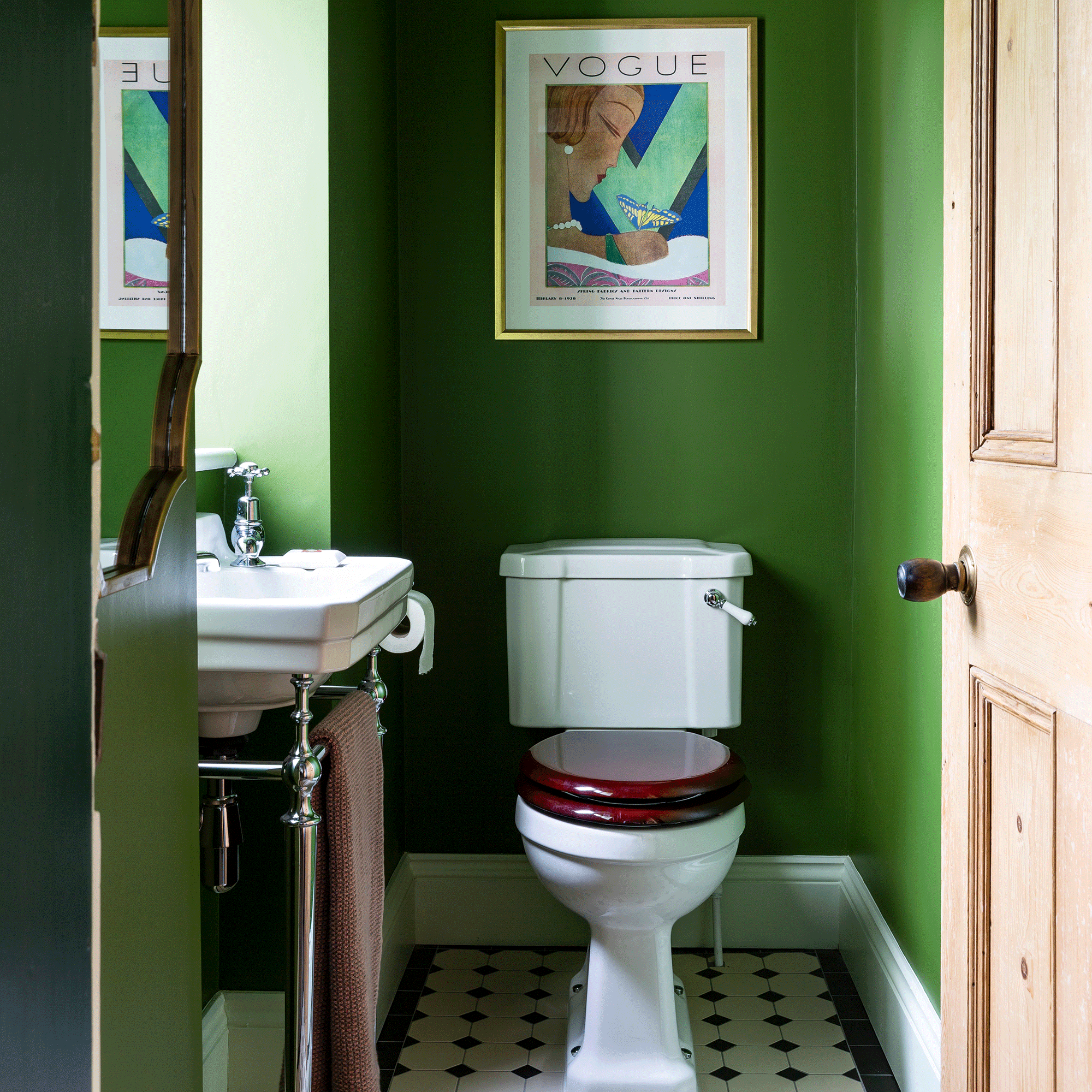 Green bathroom with artwork