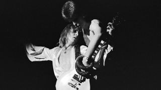 David Bowie and guitarist Mick Ronson (1945 - 1993) play a guitar together during Bowie's last appearance as Ziggy Stardust, at the Hammersmith Odeon, London, 3rd July 1973.