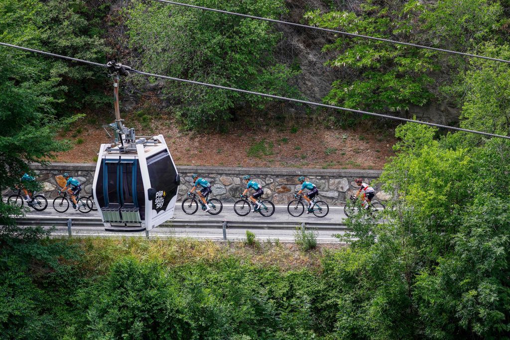 The pack of riders cycles through the ski resort of Pila during the 15th stage of the Giro dItalia 2022 cycling race 177 kilometers from Rivarolo Canavese Piedmont to Cogne Aosta Valley on May 22 2022 Photo by Luca Bettini AFP Photo by LUCA BETTINIAFP via Getty Images