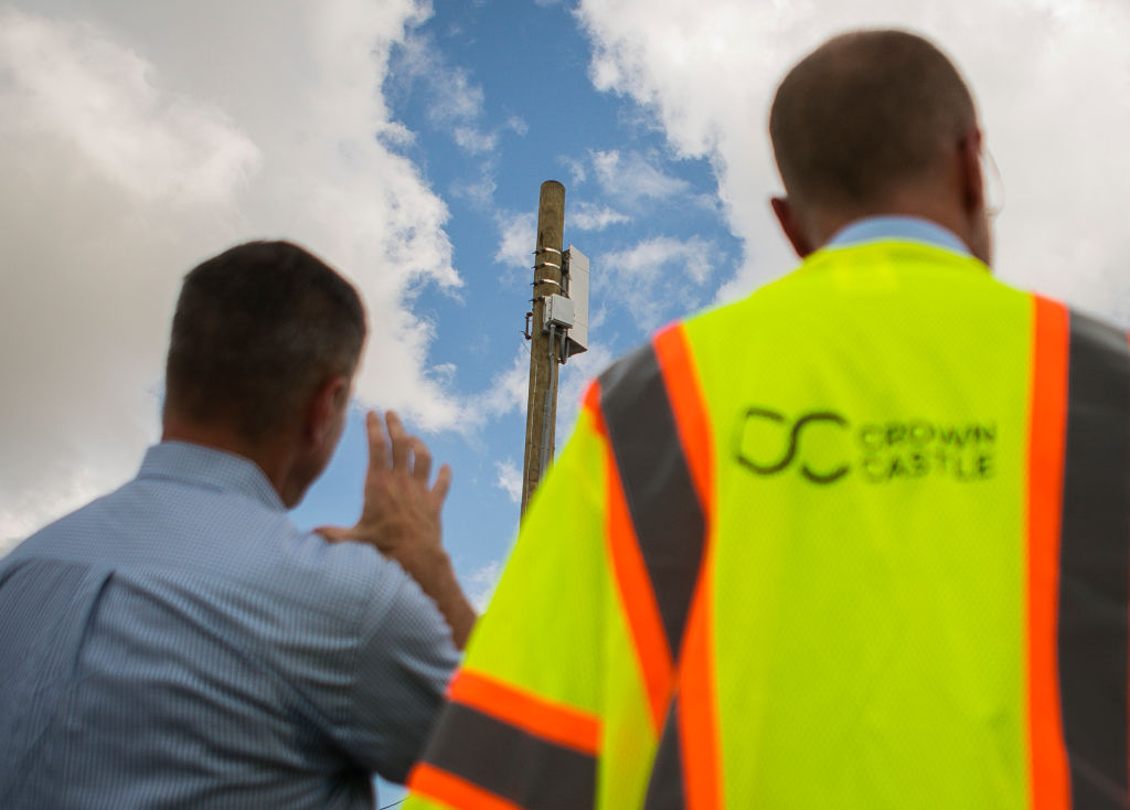 FCC Commissioner Brendan Carr looks at a small cell node capable of operating a 5G network with Crown Castle's Mike Kavanagh east of downtown Houston.