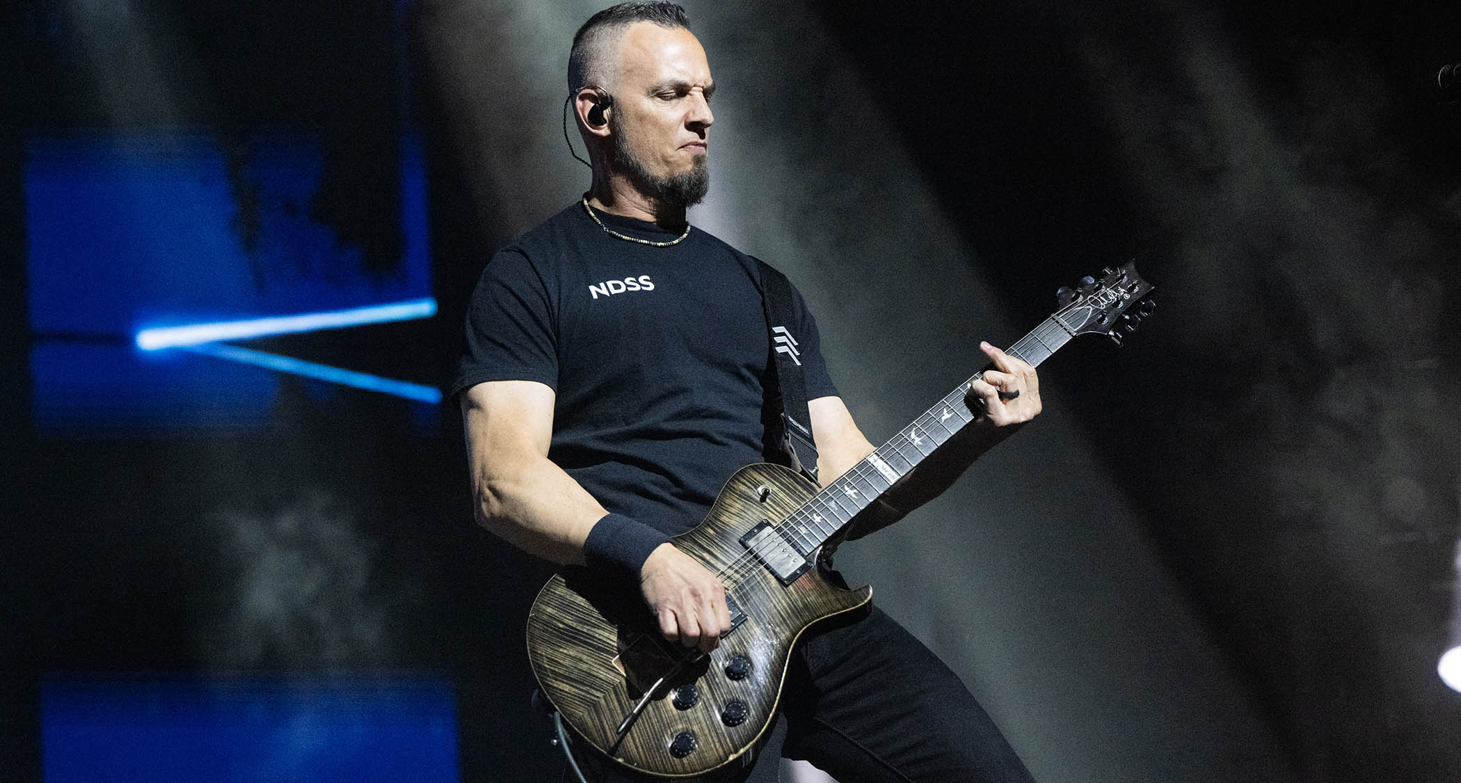 Mark Tremonti plays a big chord on his signature PRS electric guitar as he performs a 2025 live show with Creed